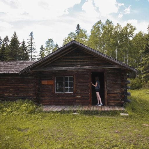 Person standing at the entrance of Grey Owl's Cabin